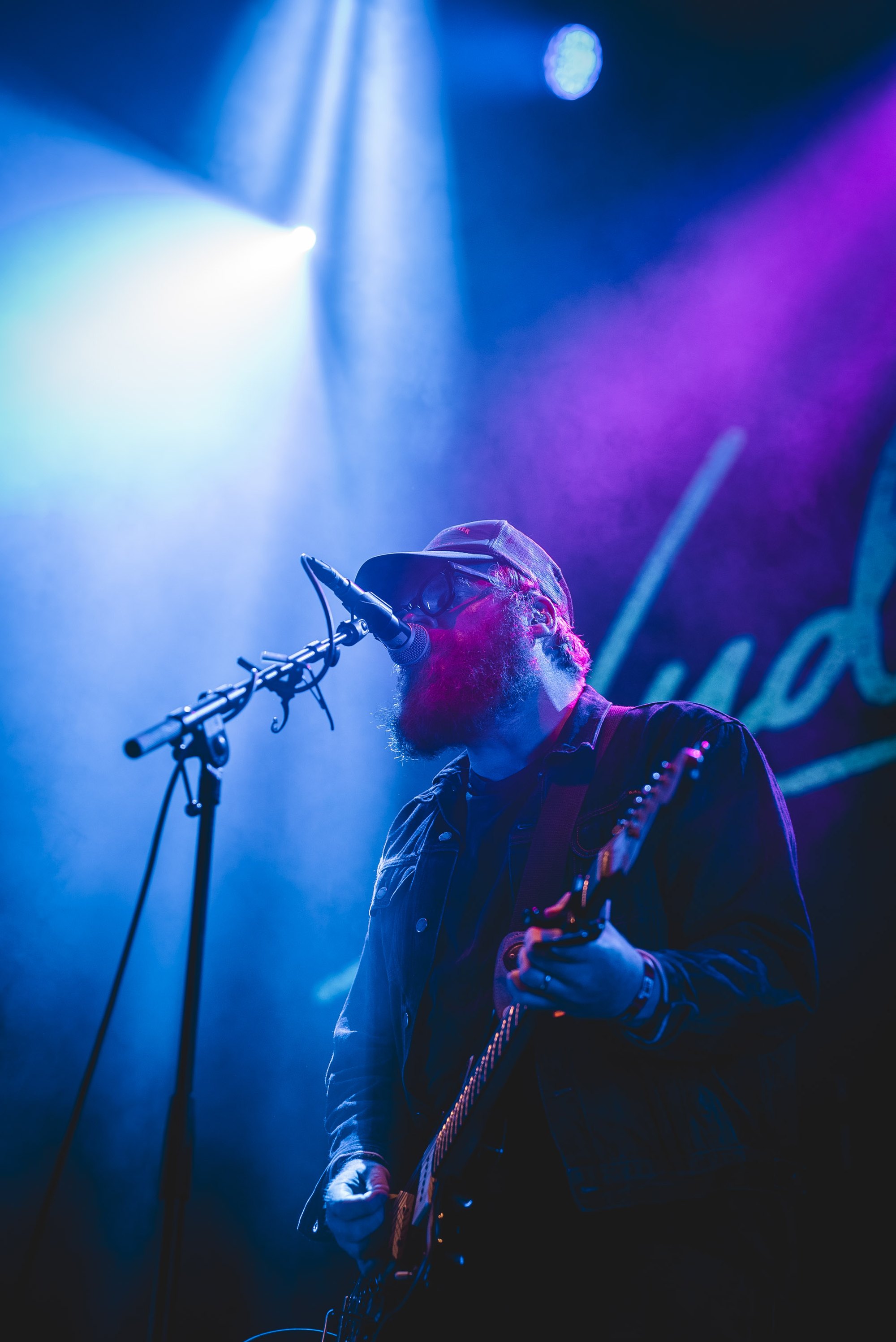 Occrasy guitarist on a blue-lit stage