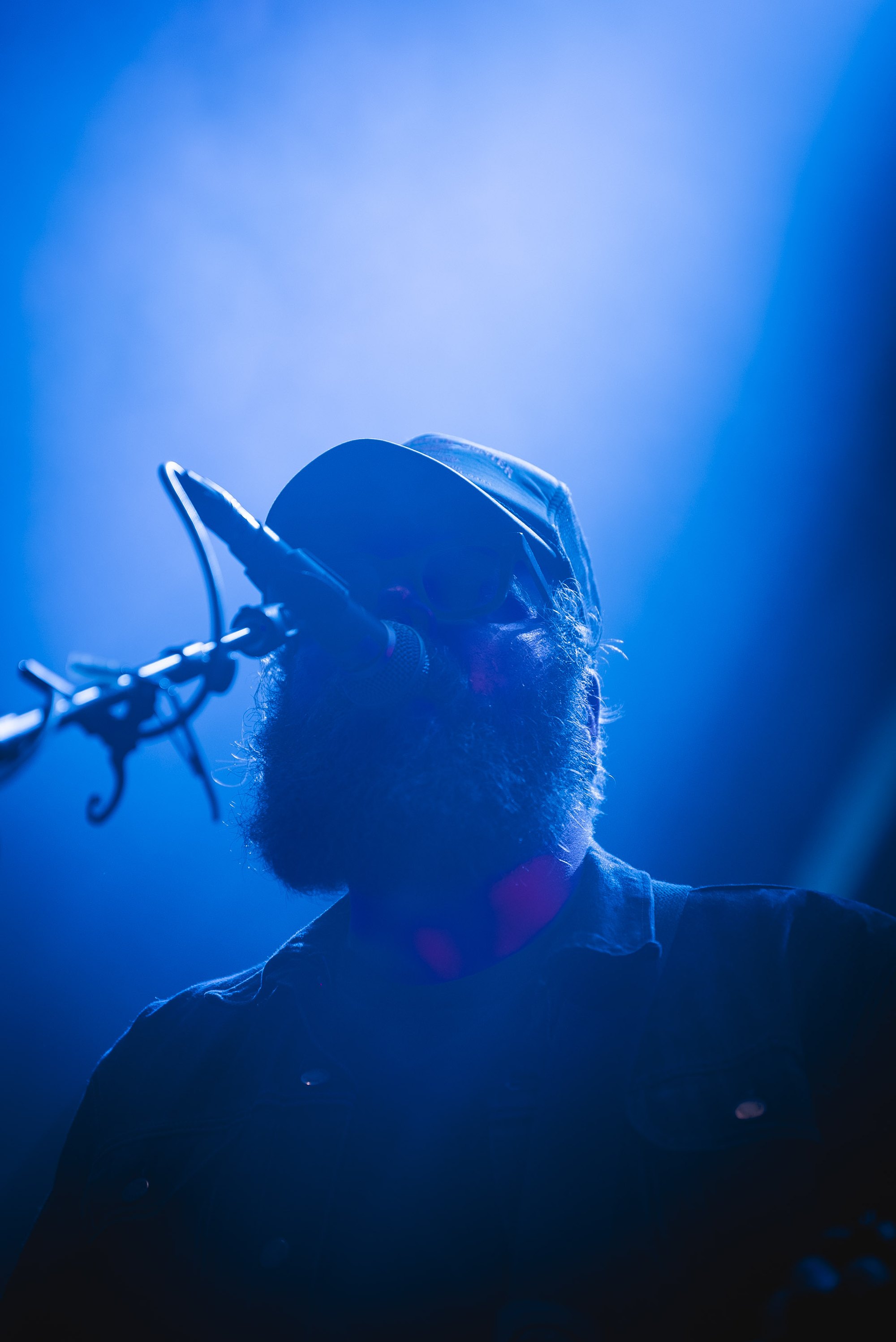Ludwig Hart performing in blue stage light