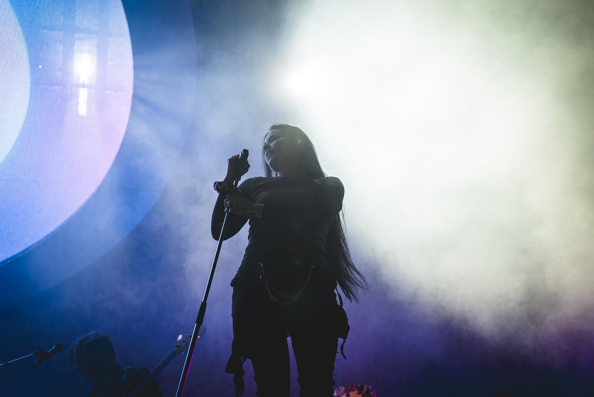 Miriam Bryant performing in blue and white stage light
